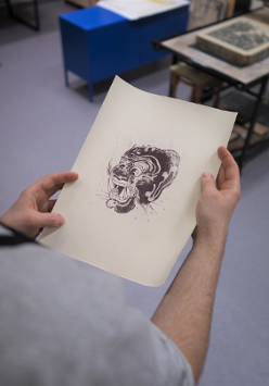 The photo shows the hands of a studio participant, holding black and white graphics.