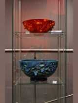 Photo from the exhibition: two vases in a glass case.