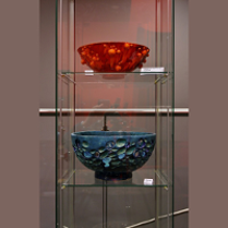 Photo from the exhibition: two vases in a glass case.