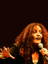 Picture of the singer with a microphone in her hand.