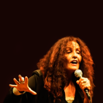 Picture of the singer with a microphone in her hand.