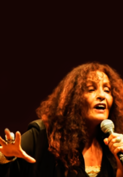Picture of the singer with a microphone in her hand.