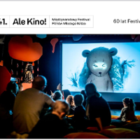 Photo of young audience watching movie on a big screen.