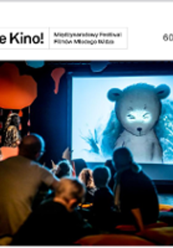 Photo of young audience watching movie on a big screen.
