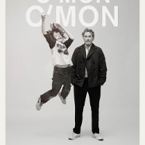 The black and white poster depicts a middle-aged man standing with his hands in his pants pockets and a teenage boy who was captured in the air after jumping.