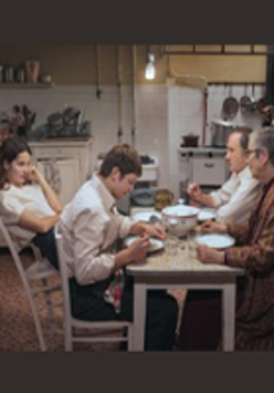Photo from movie: famili sitting at the table.