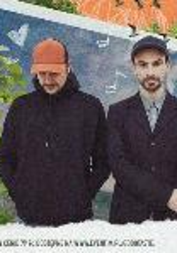 Photo of Fisz Emade - two man, one is looking down, another is looking at the camera. Blue, green and orange background.