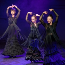 Picture of three flamenco dancers in black dresses; violet background
