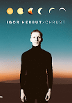 Album cover - photo of a singer in black clothes who stands straight. Brown-orange and blue background.