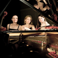 Picture of three women sitting at the grand piano