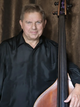 A photo of an artist Piotr Czerwiński with his double bass