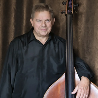 A photo of an artist Piotr Czerwiński with his double bass