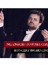 A picture of a conductor holding a baton in his hand