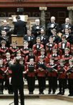 Picture of the Boys' and Men's Choir of the Poznan Philharmonic The Poznan Nightingales: boys and men singing in a few rows.