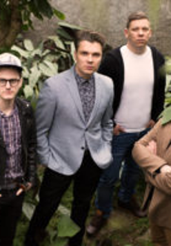 Picture of the band - four men standing and looking up at the camera