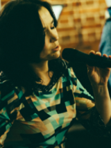 Photo of the singer with a microphone in her hand