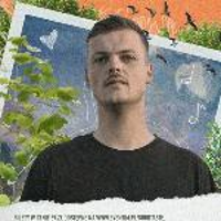 Photo of the vocalist Król. Picture presents young man looking at the camera on a blue, green and orange background