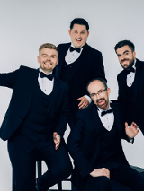 Photo of the band - four men dressed in suits
