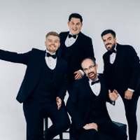 Photo of the band - four men dressed in suits