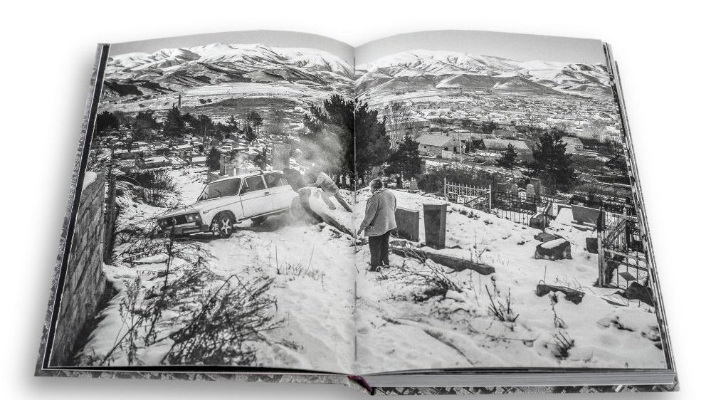 The inside of a book with a white and black photo.