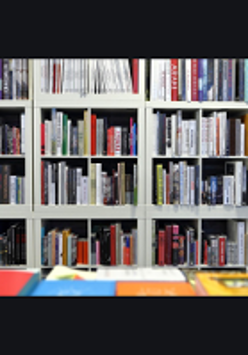 Photo of white bookshelf filled with books.