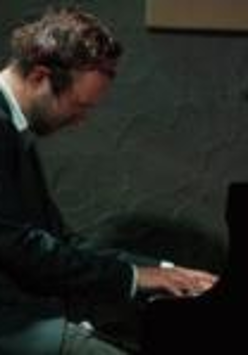 Photo of an artist playing the piano