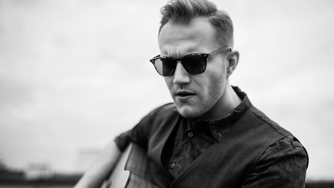 Black and white picture of a man in dark sun glasses