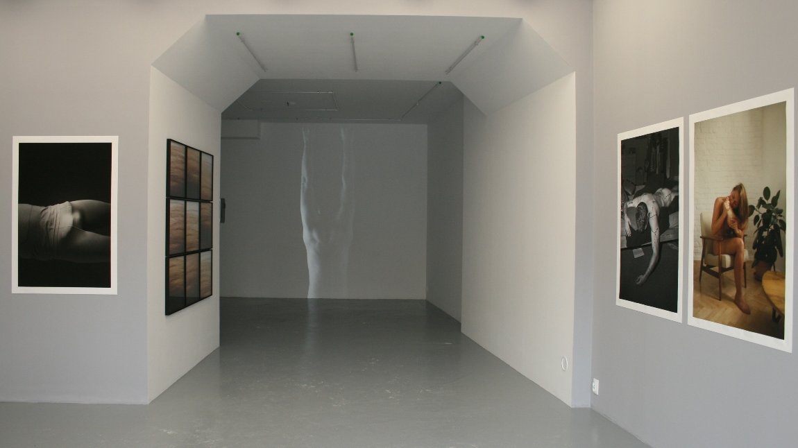 The empty lighted room with four pictures on white walls