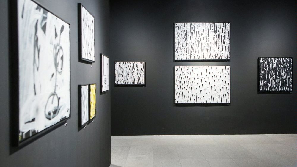 Exhibition room - a few Noriaki's pictures on grey walls.