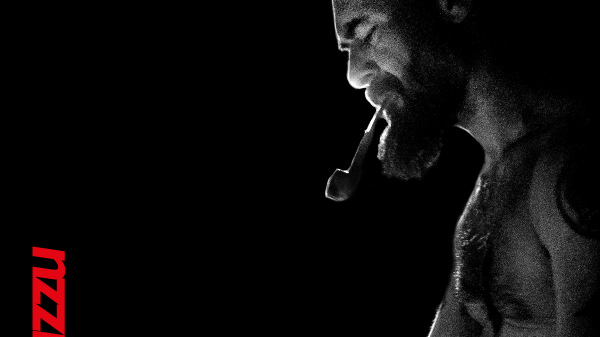 Concert poster - black and white photo of the artist on black background. At the top of the poster - information about the concert.