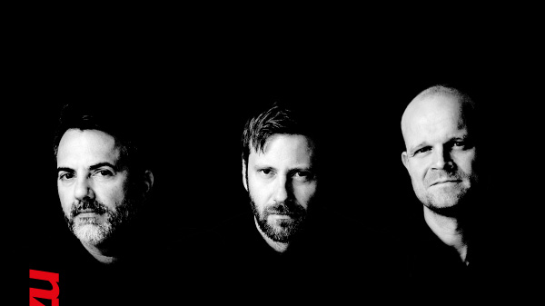 Concert poster - black and white photo of the artists on black background. At the top of the poster - information about the concert.