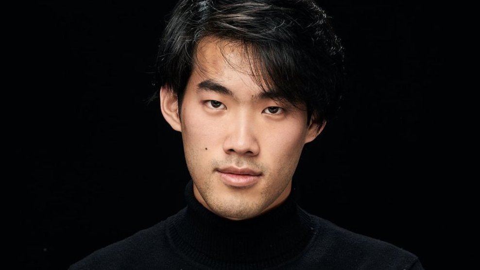 Photograph of Bruce Liu - face of the artist on the black background