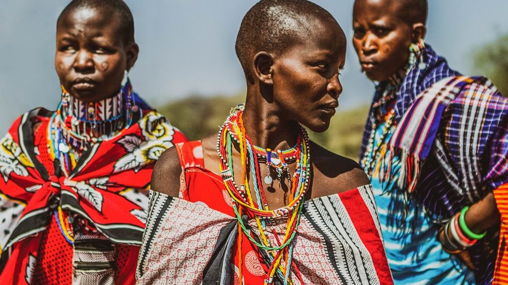 Picture from the movie - three Negro women colourfully dressed
