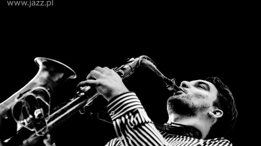 Festival poster - a man playing the saxophone and information about the festival on a black background
