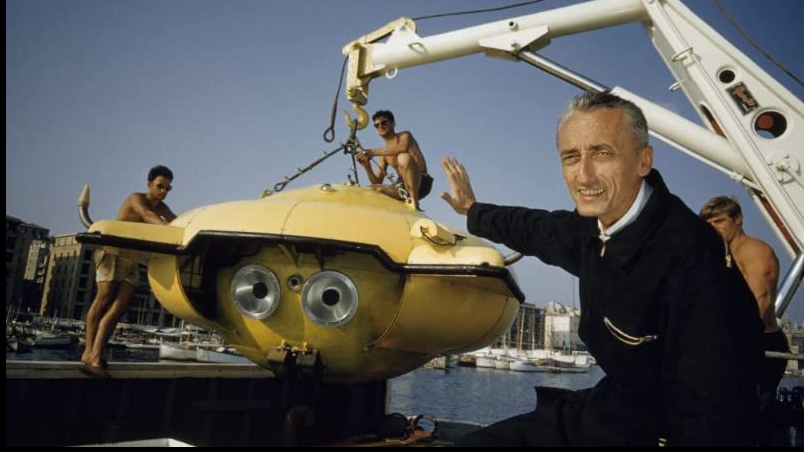 A shot from a movie: an elderly man and a metal construction with three young men standing next to it