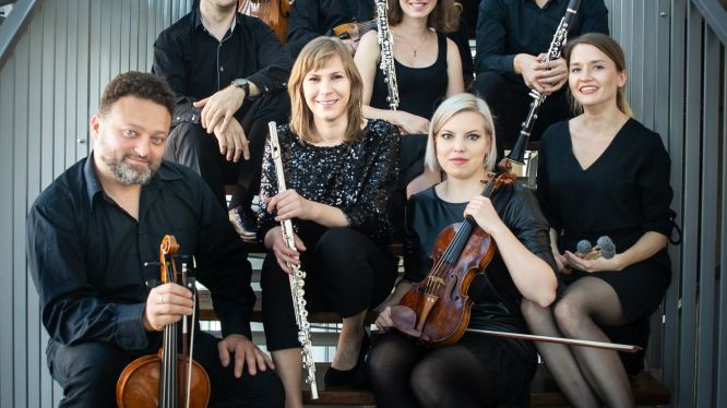 Photo of the Sepia Ensemble members sitting with them musical instruments on the stairs.
