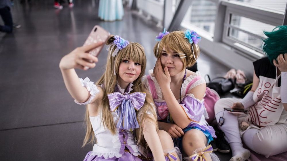 Two girls in disguise taking a selfie.