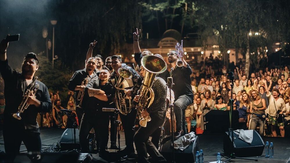 Photo of the artists performing on stage