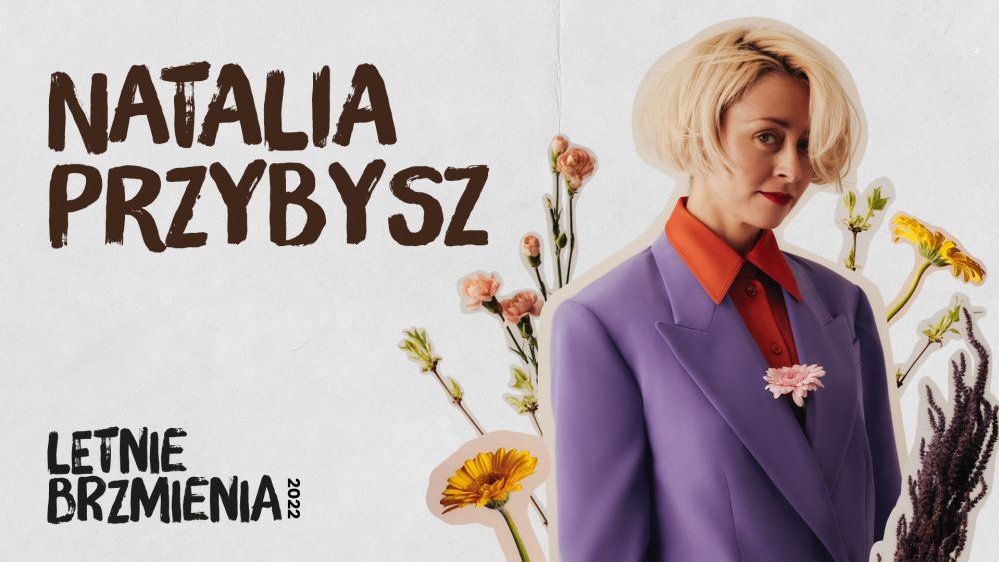 Photograph of Natalia Przybysz; a few flowers as a part of a background