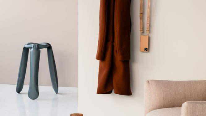 One of the exhibition works - a picture of various object in a room with white walls and white floor.