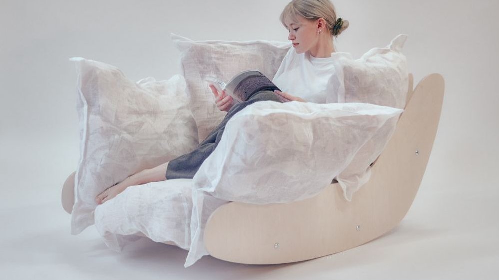 One of the exhibition works - a woman sitting and reading on a big arm-chair.