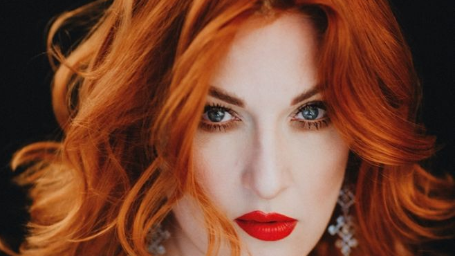 Photo of the artist on a black background.