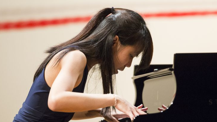 Photo of Kate Liu playing the piano.