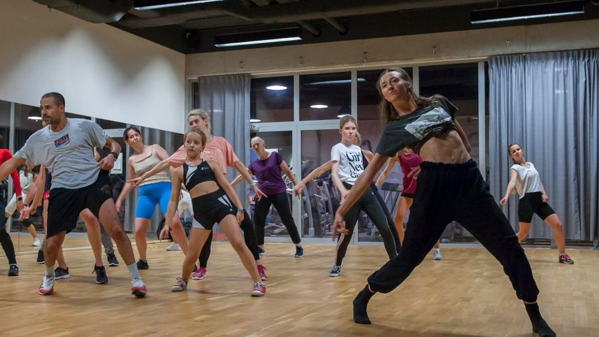 A group of dancing people in similar poses.