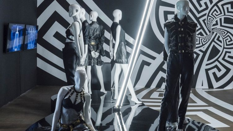 Mannequins in black and white costumes. Black and white wall as a background.