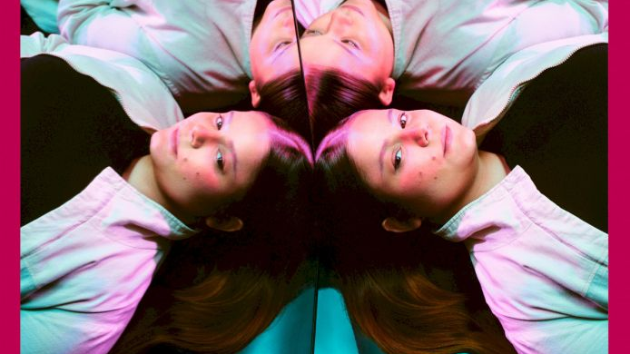 A pink festival poster with a photo of a young girl reflected four times in a mirror.