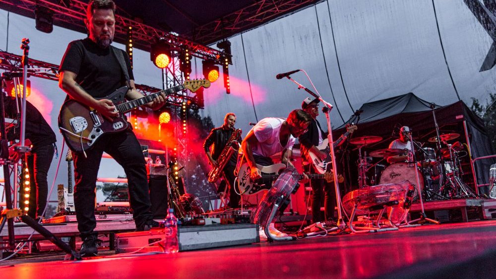 Music band on an outdoor stage. It's getting dark.