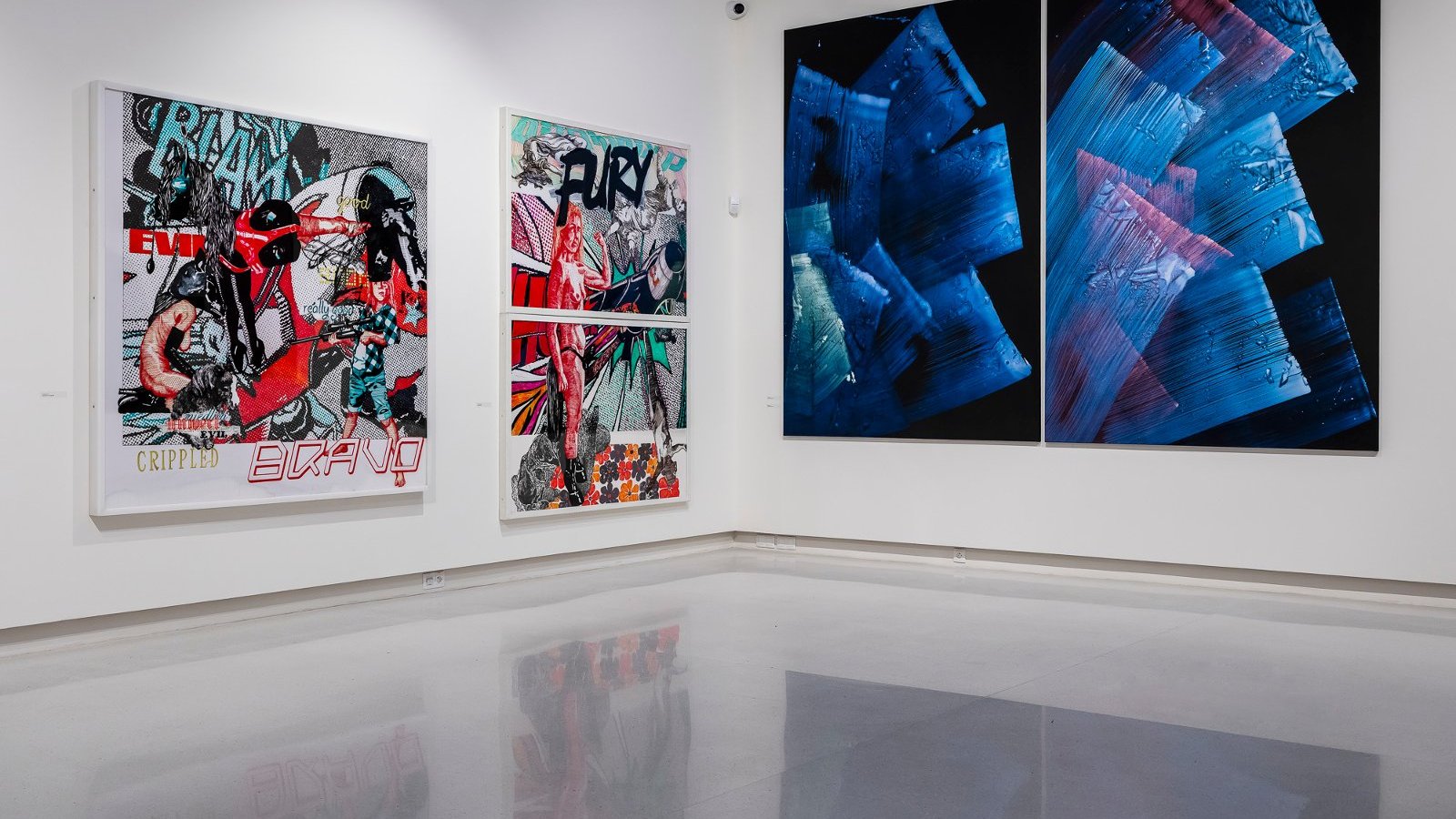 On two walls there are four abstract paintings: on the left multi-colored, on the right - in blue colors.