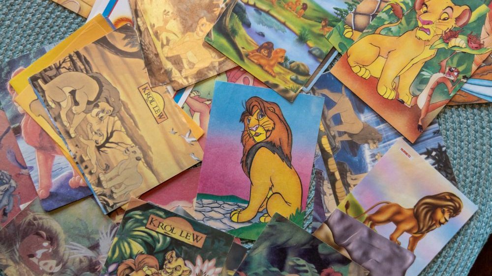 A stack of many, many cards with characters from "The Lion King." They depict baby and adult Simba.