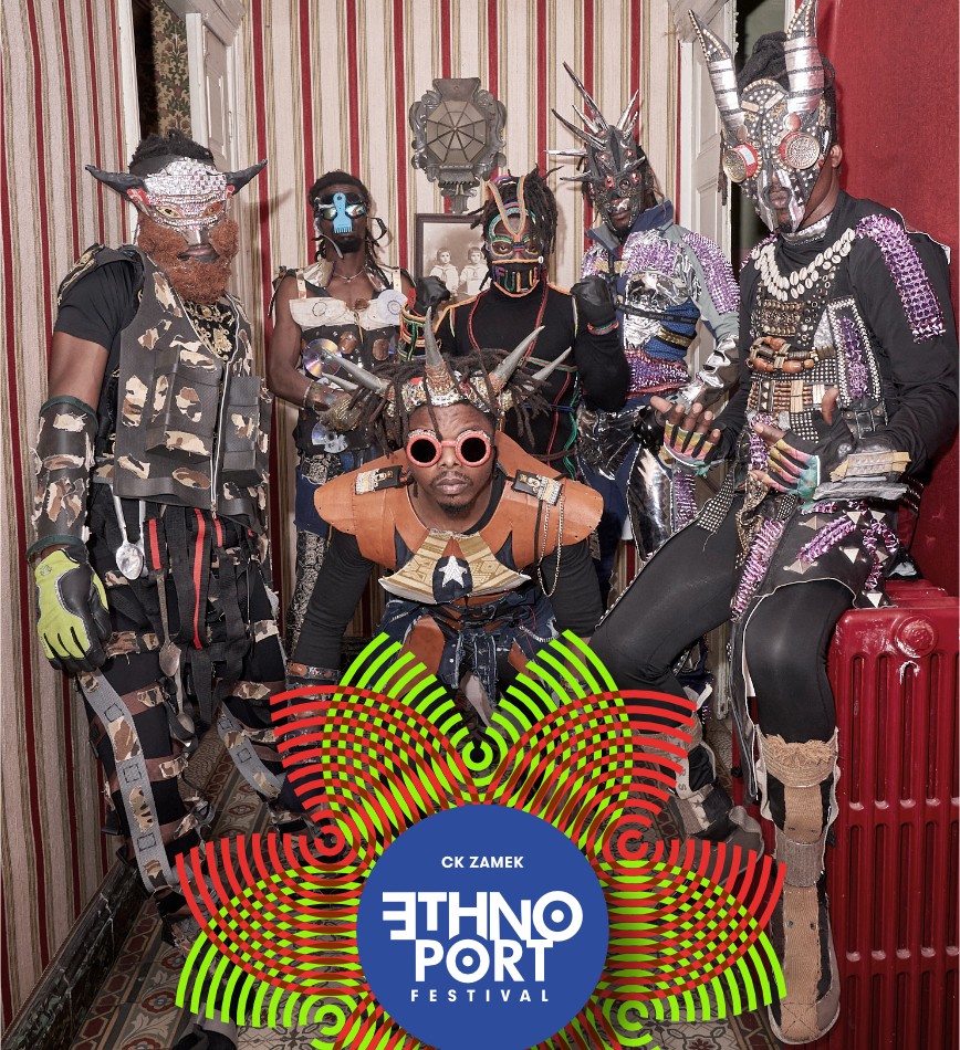 Six black men wearing fancy costumes, masks, and headbands/horns made of various materials. - grafika artykułu